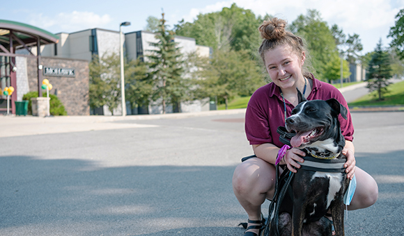 A student holds her dog outside Mohawk Hall.