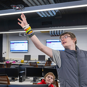 Bobby Snyder and Griffon Bunnell fly a drone during an on-campus visit.