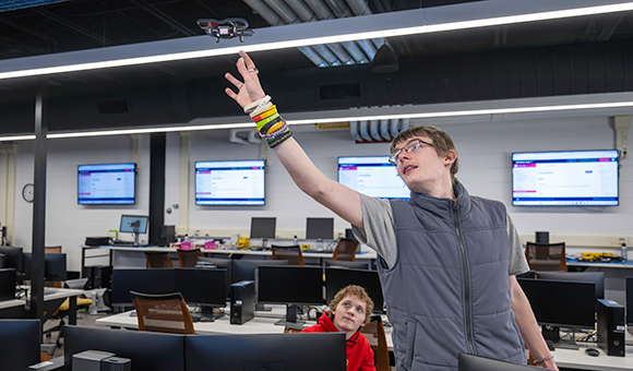 Bobby Snyder and Griffon Bunnell program and fly a drone during an on-campus visit.
