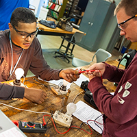 Two students work on an electrical project in the Electrical Construction lab.