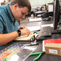 A student works with a sample motherboard.