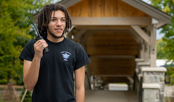 Tashmir Eggleston tests a radio near the SUNY Canton footbridges.
