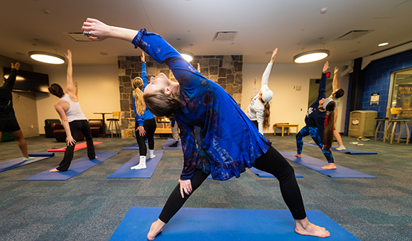 Erica Sharpe leads a yoga class in the Kingston Mezzanine
