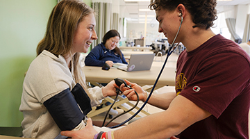 Students monitor blood pressure after exercise as part of a lab.