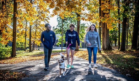 Students walking up the hill on a fall day from the residence halls.