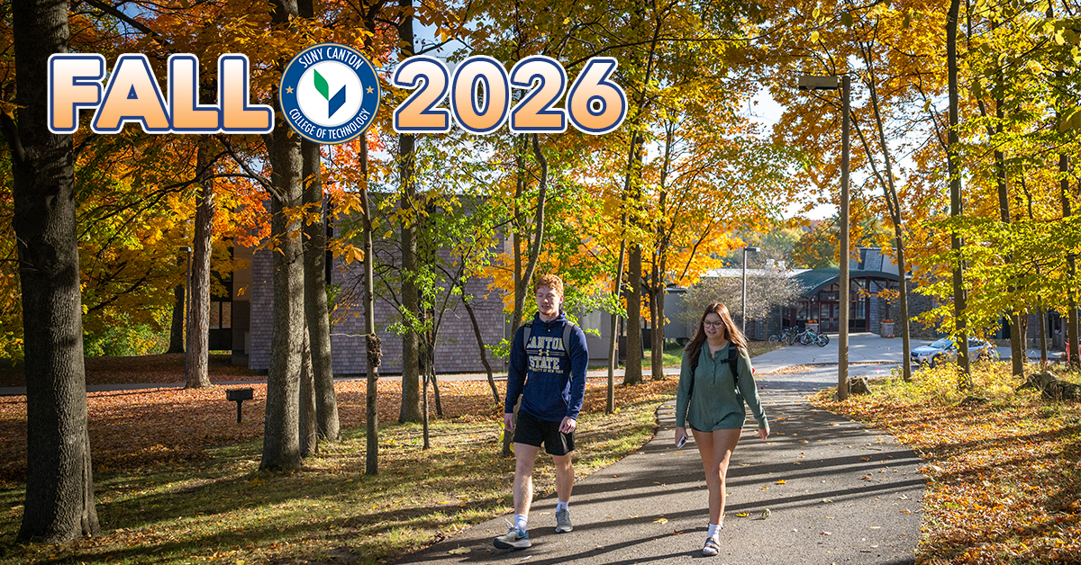 Fall 2026 - Two students walk along a pathway from the Residence Halls on a beautiful fall day.