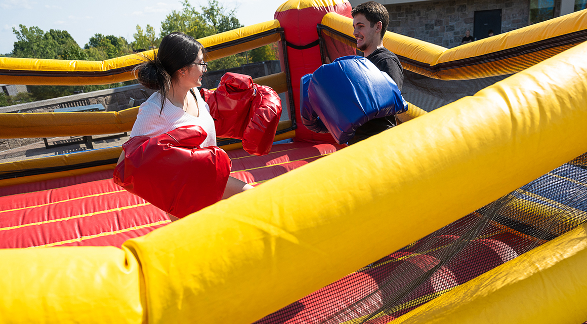 Two students box in an inflatable ring during Family and Friends Weekend.