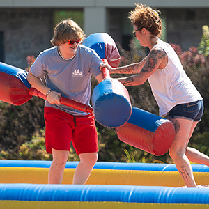 Two students joust at Family and Friends Weekend.