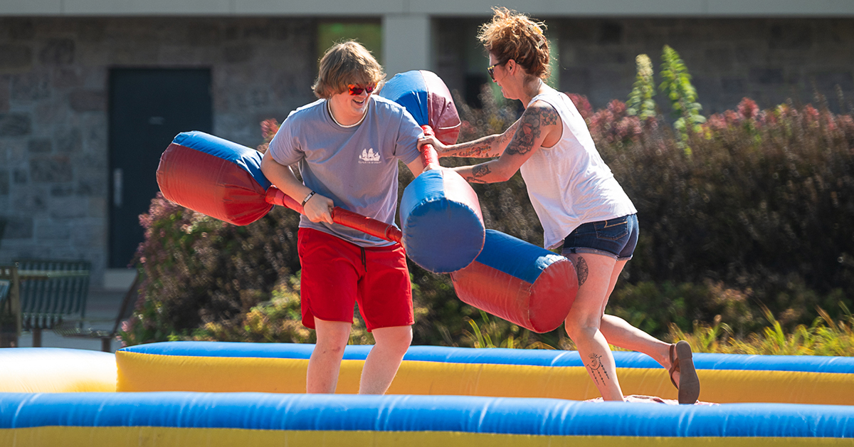 Two students joust at Family and Friends Weekend.