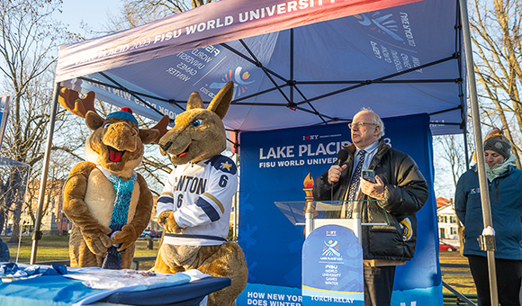 Mac the Moose and Roody Roo join President Szafran on stage on the Village Green during the FISU Torch Relay Celebration.