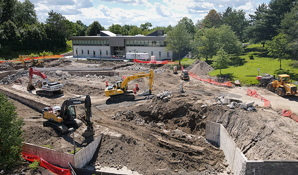 Crews work to clear the Roselle Plaza outside French Hall.