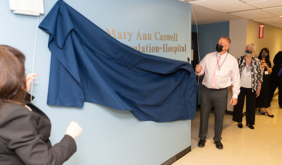 racey Thompson and George Caswell unveiling the new sign commemorating the Caswell family’s donation to honor the late Mary Ann Caswell.