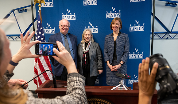 President Zvi Szafran, Senator Kirsten Gillibrand and Lenore VanderZee pose for a photo.