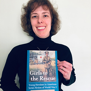 Emily Hamilton-Honey holds her new book, Girls to the Rescue.