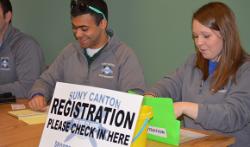 Students work the registration table.