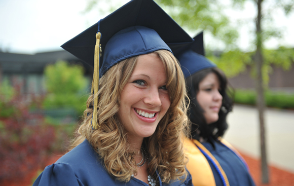 A graduate smiles for the camera