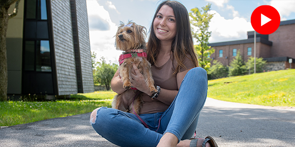 Hannah and her pet dog Maggie outside the residence halls.