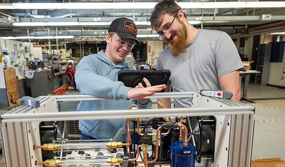Dylan Munk and Harold Bush analyze a heat pump in SUNY Canton’s Air Conditioning lab.