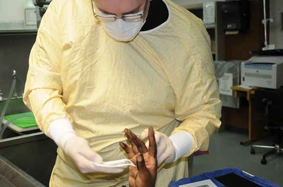 Hedberg takes finger prints from a victim