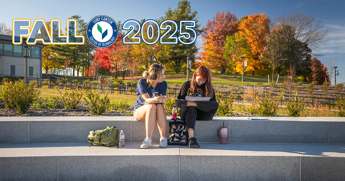 Two students studying on the steps near French Hall.