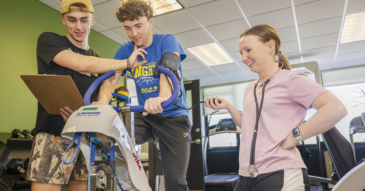 Liam Waite, Connor Flack, and Morgan Cole work through a series of stationary bike exercises during a lab in Wicks Hall
