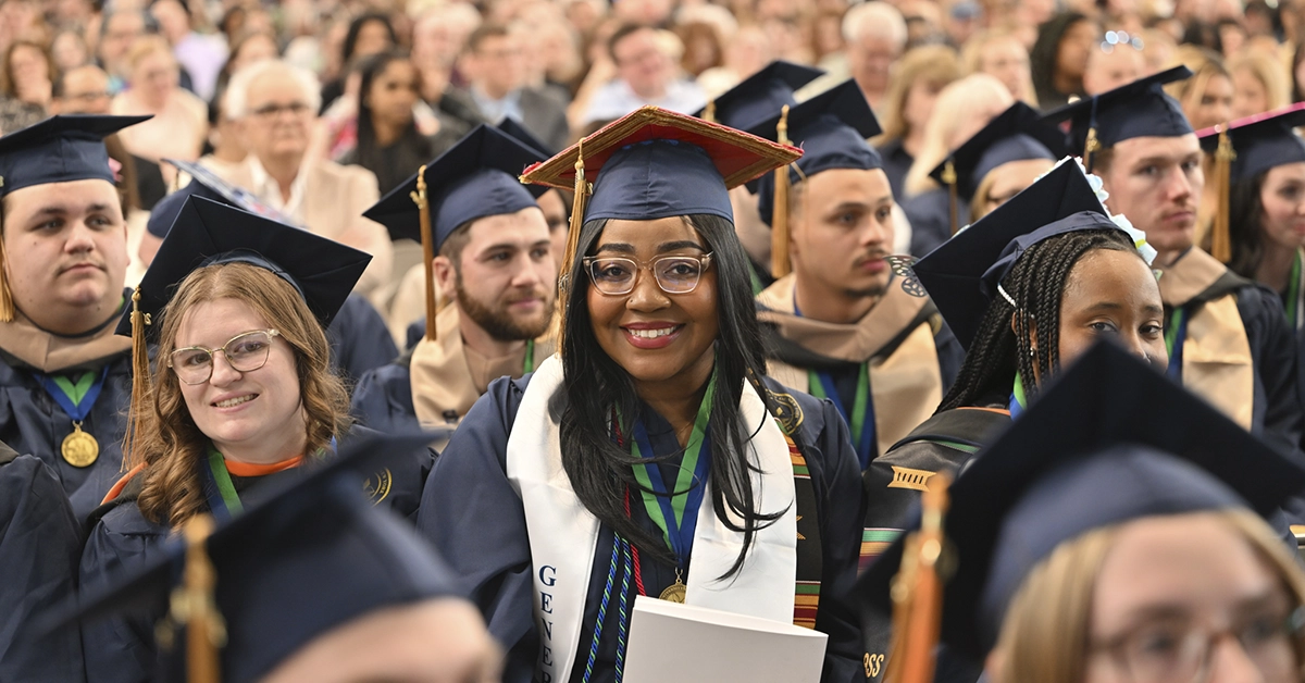 Excited graduates smile from the audience during Commencement 2026.