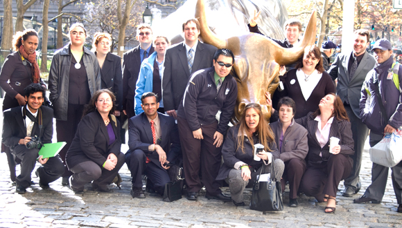 Students pose next to the Bull near Wall St.