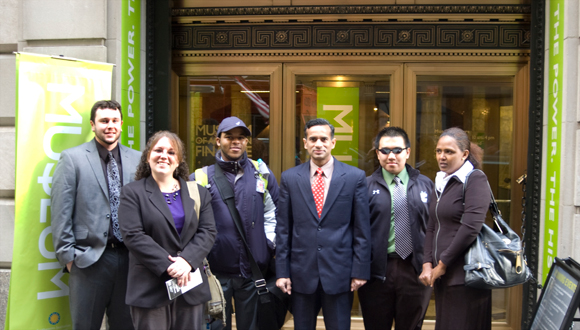Students and Professor Kumar pose in front of the NYSE