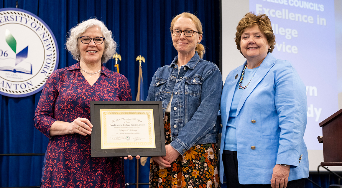 Katie Kennedy receives her award from College Council members Kathy Dodge and Jenn Stevenson.