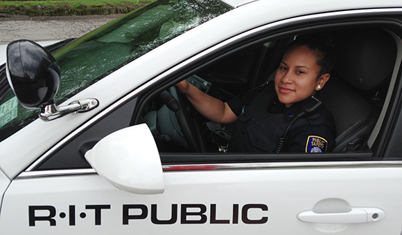 Langomas sits in her patrol car