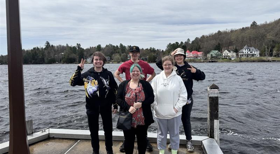 Liberty students stand at the end of a dock during the Empire Summit in Saranac Lake.