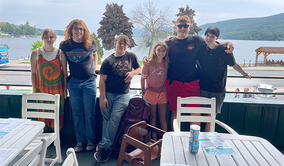 Liberty students pose at a restaurant overlooking Lake George.