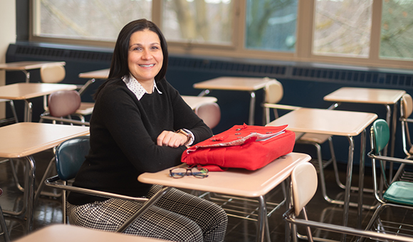 Marela Fiacco sits at a desk.