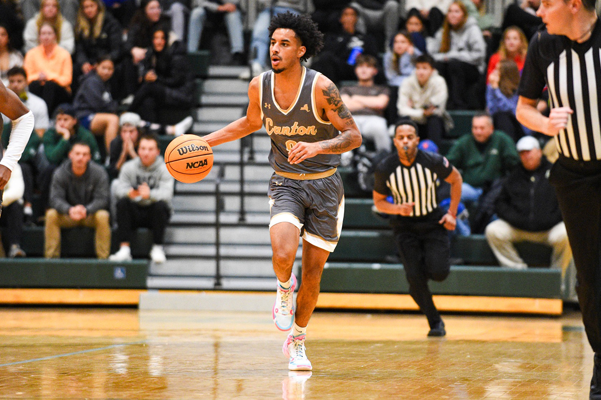 A men's basketball player drives to the lane.