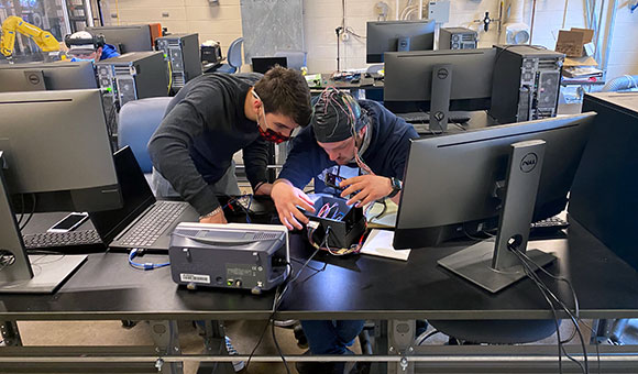 Two students work on a project in the Mechatronics lab.