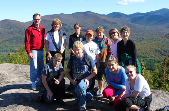 Students sitting on the top of Mt. Joe