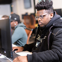 A student at a computer in the Cybersecurity lab.