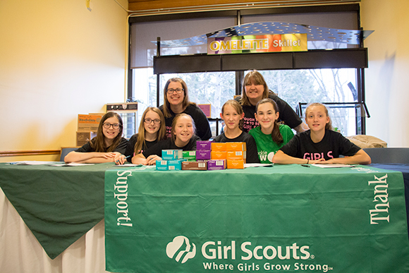 Girl scouts hand out boxes of cookies at Chaney Dining Center.