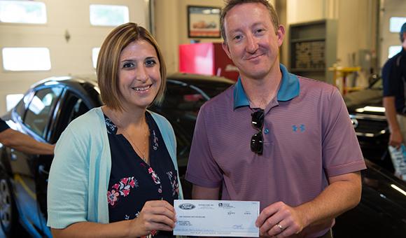 Steve Blevins presents Beth Gravlin with a check for the Leland Blevins Family Endowed Scholarship.