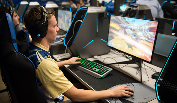 A students plays Overwatch with his team in the Esports Arena.