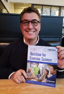 Dan Benardot holds up his book, Nutrition for Exercise Science