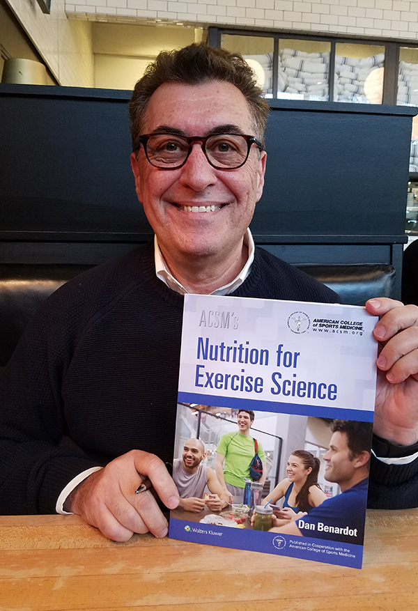 Dan Benardot holds up his book, Nutrition for Exercise Science
