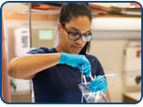 A nursing student sets up an IV kit.