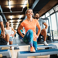 A peer educator leads a class at a gym.