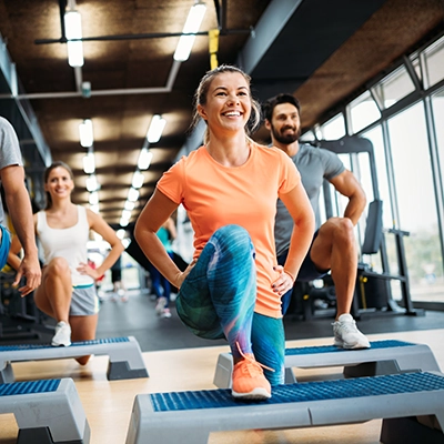 A peer educator leads a class at a gym.