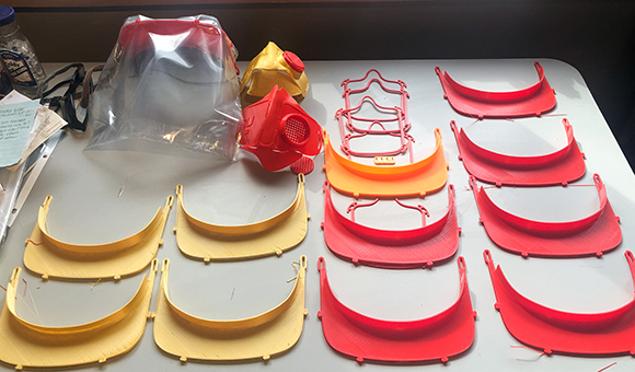 Pictured are some of the 3D printed components for medical face shields made by SUNY Canton Graphic and Multimedia Design Professor Matthew J. Burnett.