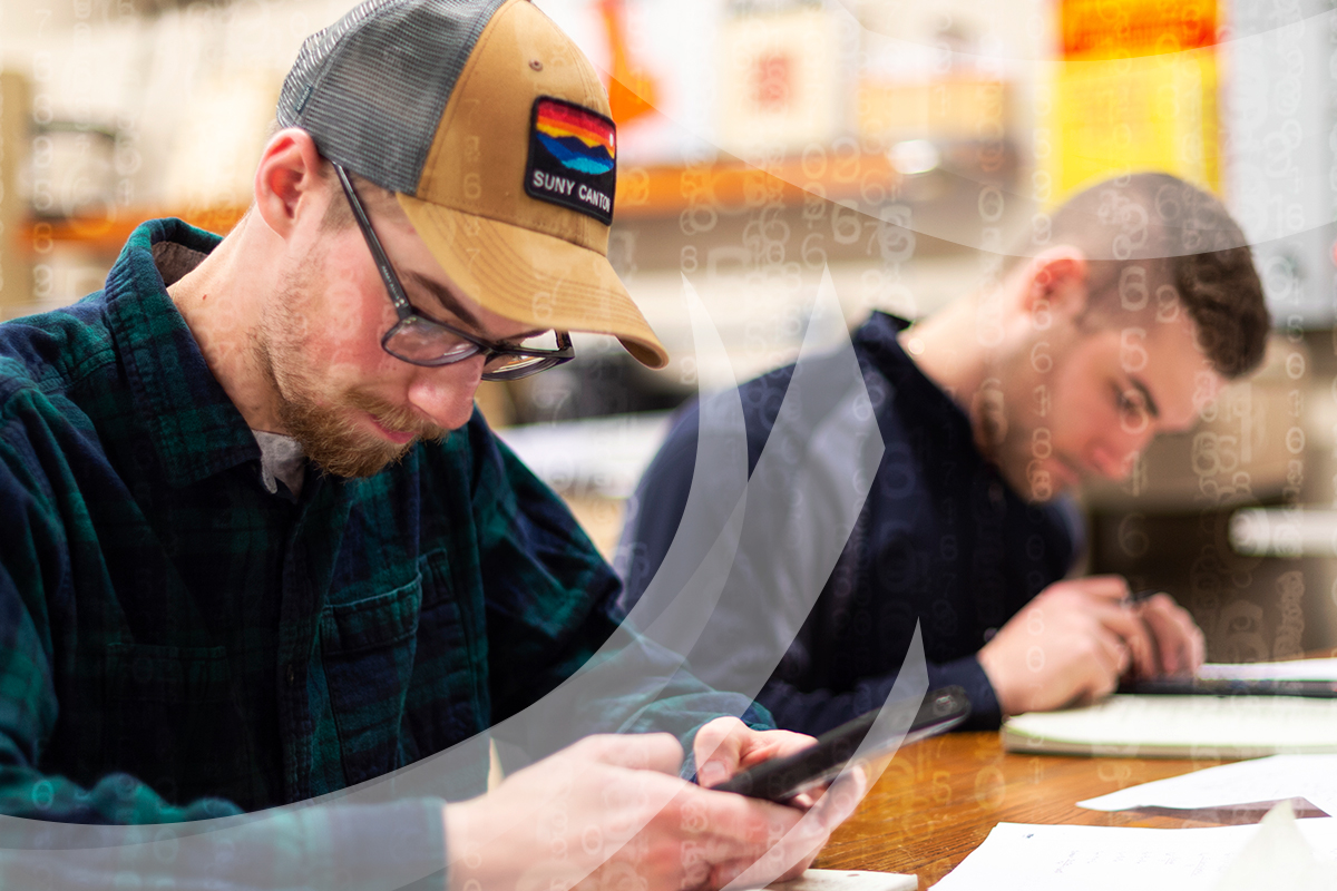 Two engineering students using calculators in the Electrical Lab.