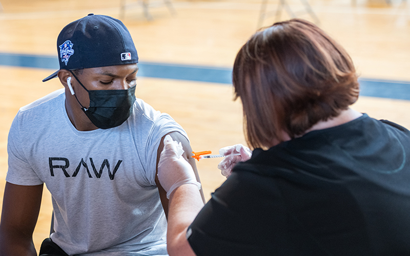 A student gets vaccinated during a recent clinic in Dana Hall.