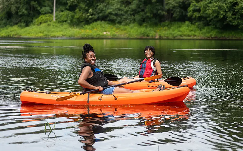 Two students in kayaks on the Grasse River.