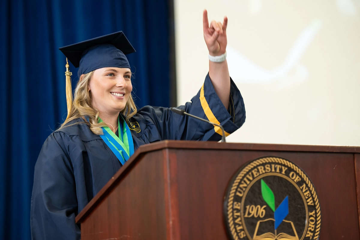 Gracyn Emmerton gives the Roo hand gesture at Commencement 2023.